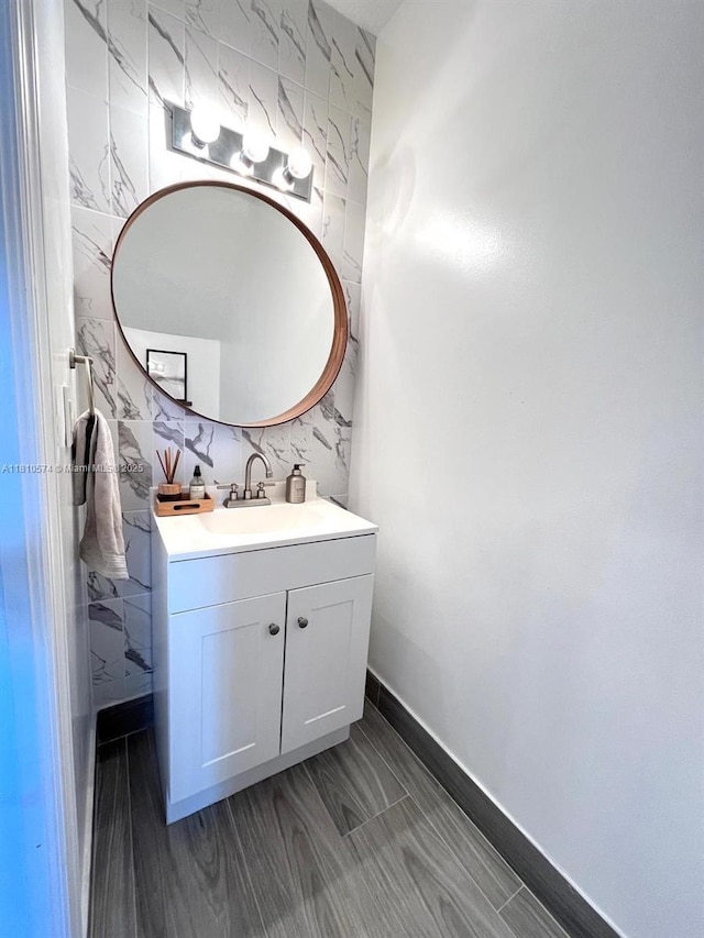 5670 NW 116th Ave Unit 212, Doral, FL 33178 - bathroom featuring vanity, tile walls, and baseboards