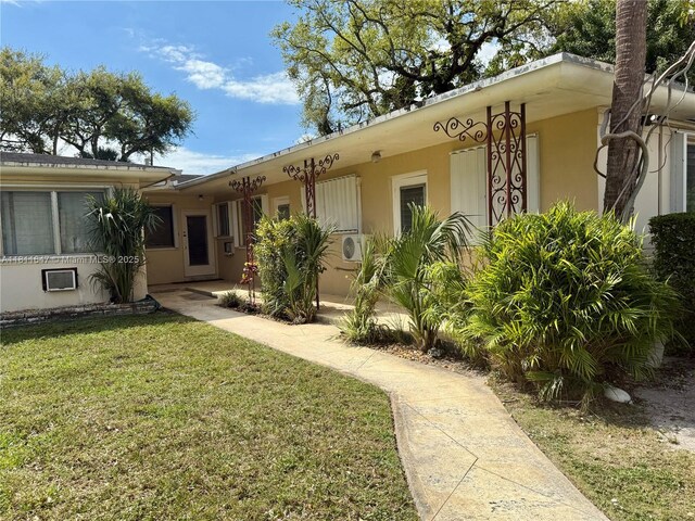 1570 NE 130th St, North Miami, FL 33161 - view of front of property featuring a front lawn and stucco siding