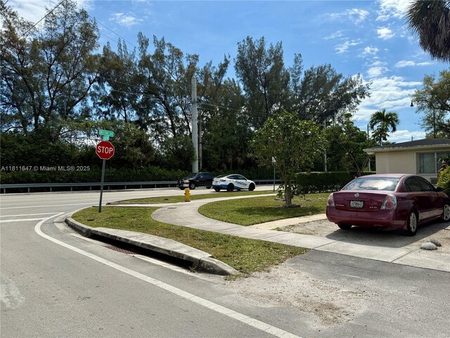 1570 NE 130th St, North Miami, FL 33161 - view of asphalt road featuring traffic signs