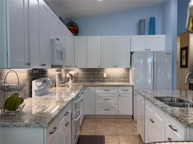 16306 SW 11th St, Pembroke Pines, FL 33027 - kitchen with white appliances, a sink, white cabinets, backsplash, and light tile patterned floors