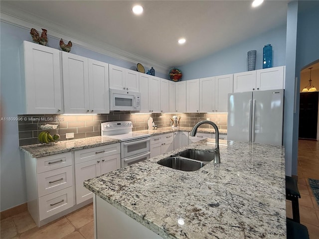 16306 SW 11th St, Pembroke Pines, FL 33027 - kitchen featuring white appliances, a sink, decorative backsplash, white cabinetry, and recessed lighting