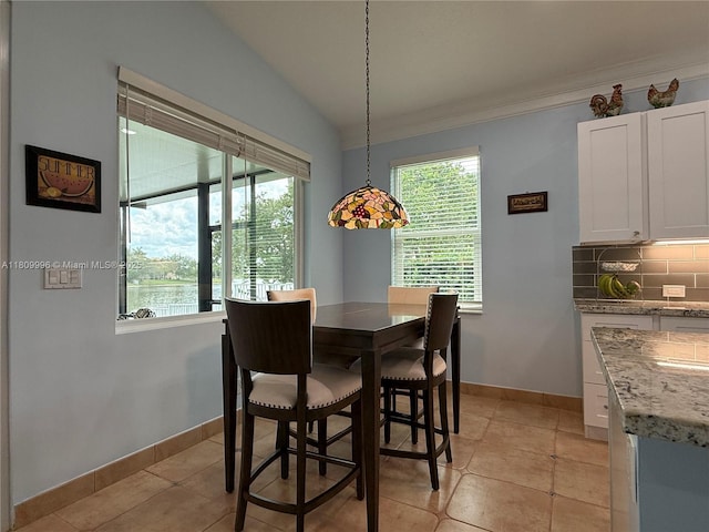 16306 SW 11th St, Pembroke Pines, FL 33027 - dining area featuring healthy amount of natural light, baseboards, lofted ceiling, light tile patterned floors, and crown molding