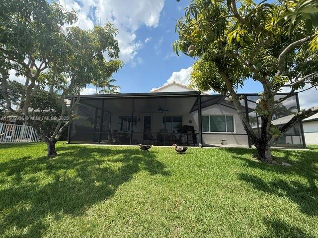 16306 SW 11th St, Pembroke Pines, FL 33027 - back of house featuring a lawn and a ceiling fan