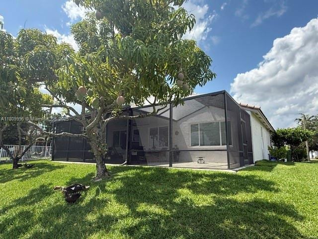 16306 SW 11th St, Pembroke Pines, FL 33027 - back of house featuring a yard and a lanai