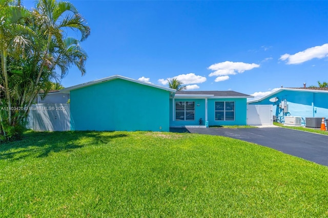 12351 NW 29th Mnr, Sunrise, FL 33323 - view of front of property featuring cooling unit, a front lawn, driveway, and stucco siding