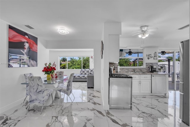12351 NW 29th Mnr, Sunrise, FL 33323 - dining space with a ceiling fan, baseboards, and light marble finish flooring