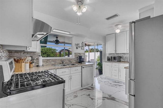 12351 NW 29th Mnr, Sunrise, FL 33323 - kitchen with stainless steel appliances, ceiling fan, decorative backsplash, a sink, and range hood