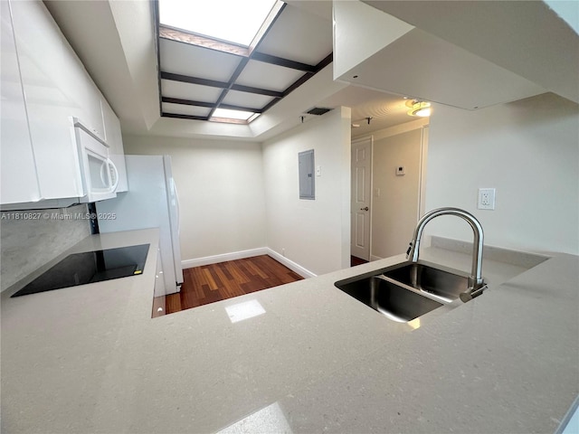 520 Brickell Key Dr Unit A811, Miami, FL 33131 - kitchen featuring a sink, black electric cooktop, electric panel, white cabinetry, and white microwave