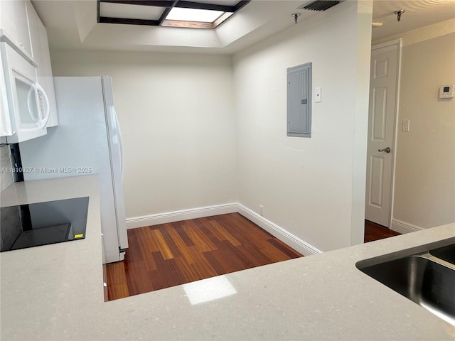 520 Brickell Key Dr Unit A811, Miami, FL 33131 - kitchen featuring electric panel, wood finished floors, white microwave, black electric cooktop, and baseboards