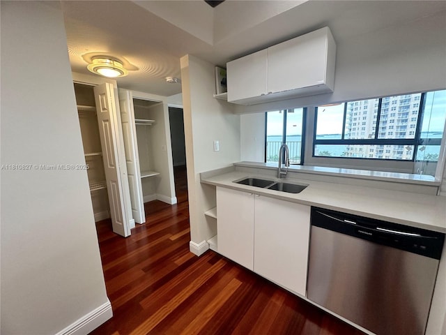 520 Brickell Key Dr Unit A811, Miami, FL 33131 - kitchen featuring stainless steel dishwasher, a sink, dark wood-style floors, white cabinetry, and light countertops