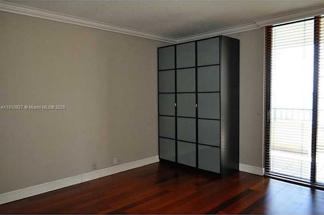 520 Brickell Key Dr Unit A811, Miami, FL 33131 - empty room with dark wood-style flooring, ornamental molding, and baseboards