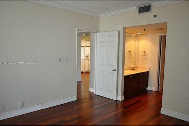 520 Brickell Key Dr Unit A811, Miami, FL 33131 - unfurnished bedroom featuring crown molding, dark wood-type flooring, a sink, and baseboards