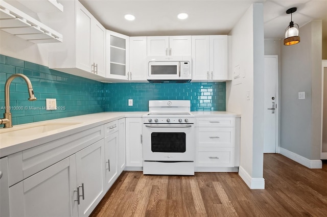 150 SE 25th Rd Unit 10K, Miami, FL 33129 - kitchen featuring white appliances, a sink, wood finished floors, white cabinetry, and recessed lighting