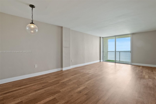 150 SE 25th Rd Unit 10K, Miami, FL 33129 - spare room with wood finished floors, expansive windows, and baseboards
