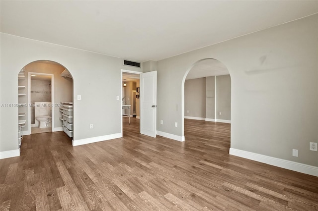 150 SE 25th Rd Unit 10K, Miami, FL 33129 - unfurnished room with wood finished floors, baseboards, and arched walkways