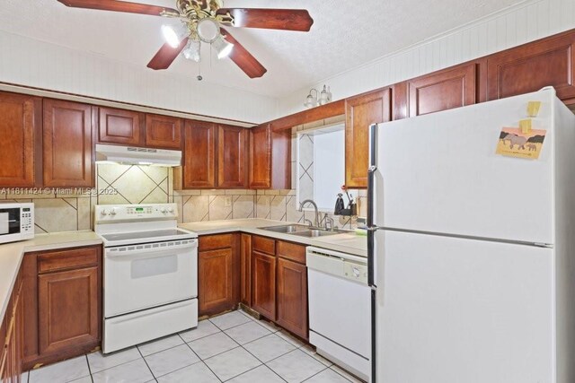 1090 SW 31st St, Fort Lauderdale, FL 33315 - kitchen featuring white appliances, under cabinet range hood, decorative backsplash, a sink, and light countertops