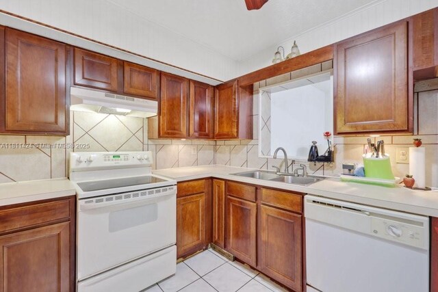 1090 SW 31st St, Fort Lauderdale, FL 33315 - kitchen featuring white appliances, under cabinet range hood, a sink, and light countertops