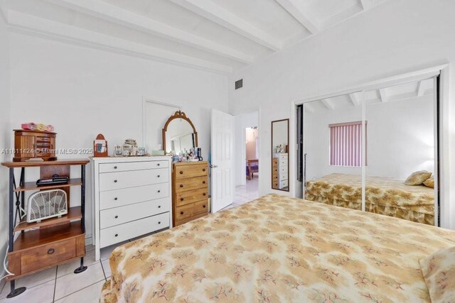 1090 SW 31st St, Fort Lauderdale, FL 33315 - bedroom featuring tile patterned floors, beamed ceiling, and a closet