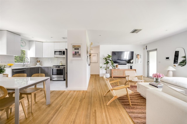 6055 SW 38th St, Miami, FL 33155 - living area with light wood-style floors and baseboards