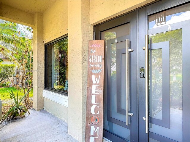 21241 SW 88th Pl, Cutler Bay, FL 33189 - view of exterior entry with french doors and stucco siding