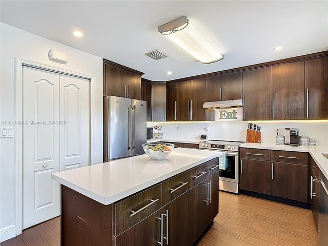 21241 SW 88th Pl, Cutler Bay, FL 33189 - kitchen featuring appliances with stainless steel finishes, under cabinet range hood, dark brown cabinetry, light countertops, and recessed lighting