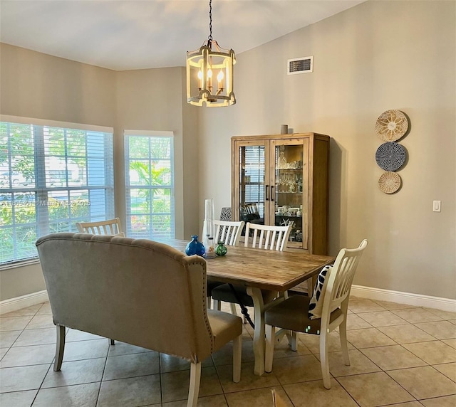 20390 NW 2nd St, Pembroke Pines, FL 33029 - dining space featuring a chandelier, healthy amount of natural light, light tile patterned flooring, and baseboards