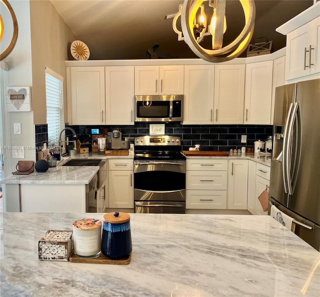 20390 NW 2nd St, Pembroke Pines, FL 33029 - kitchen with stainless steel appliances, a sink, white cabinets, and backsplash