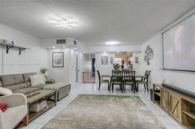 834 W 80th Pl, Hialeah, FL 33014 - living area with light tile patterned flooring and a textured ceiling