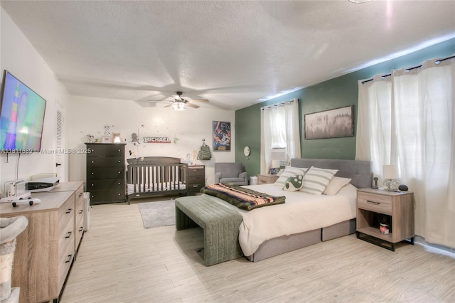 834 W 80th Pl, Hialeah, FL 33014 - bedroom featuring light wood finished floors, a textured ceiling, and a ceiling fan
