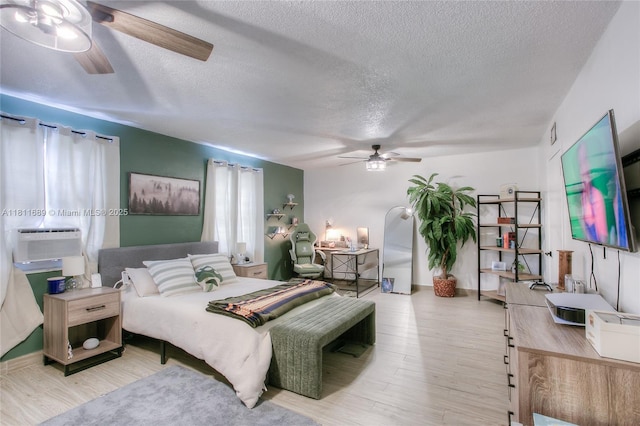 834 W 80th Pl, Hialeah, FL 33014 - bedroom featuring wood finished floors, a textured ceiling, cooling unit, and a ceiling fan