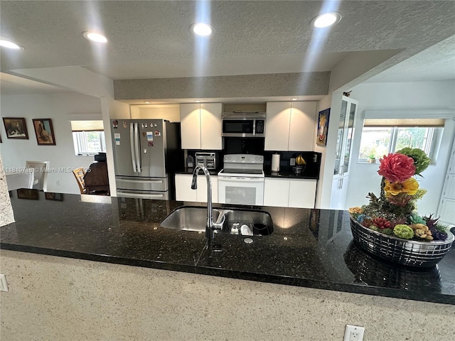 13700 SW 14th St Unit 412D, Pembroke Pines, FL 33027 - kitchen with appliances with stainless steel finishes, white cabinets, recessed lighting, a sink, and a textured ceiling