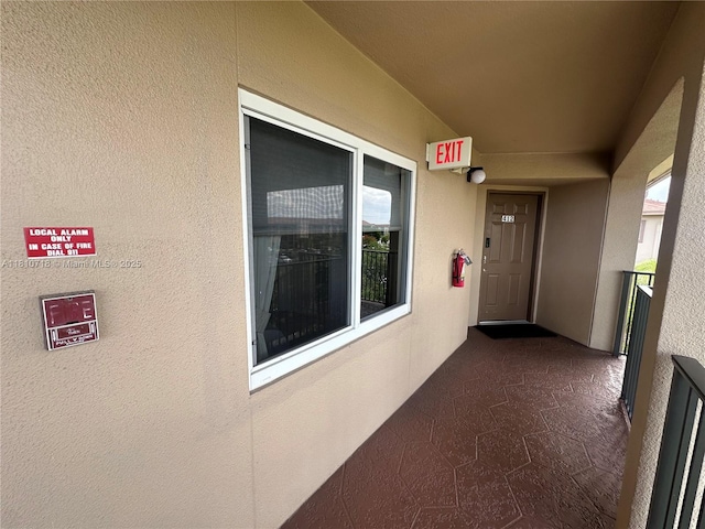 13700 SW 14th St Unit 412D, Pembroke Pines, FL 33027 - view of exterior entry featuring stucco siding and a balcony