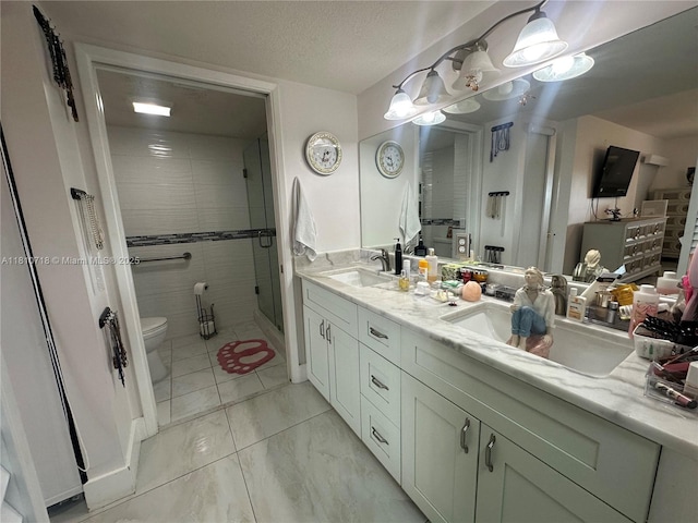 13700 SW 14th St Unit 412D, Pembroke Pines, FL 33027 - bathroom with double vanity, a shower stall, a textured ceiling, and marble finish floors
