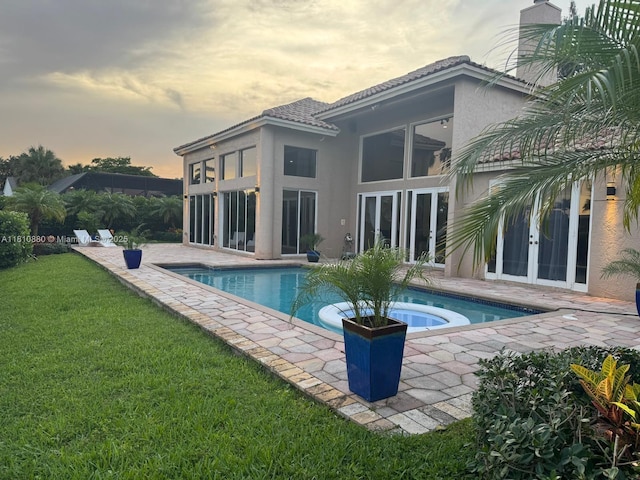 10427 Stonebridge Blvd, Boca Raton, FL 33498 - outdoor pool featuring french doors, a patio, an in-ground hot tub, and a yard