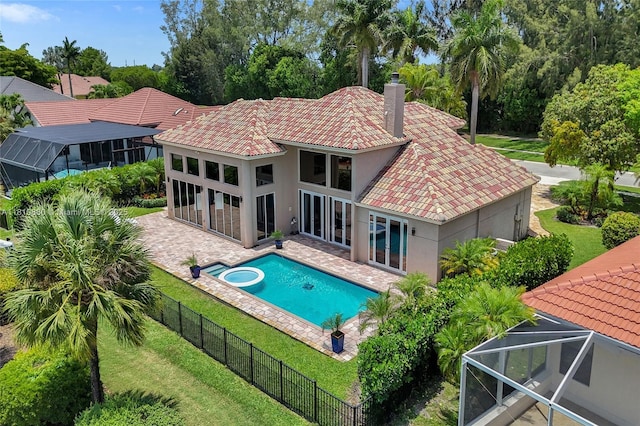 10427 Stonebridge Blvd, Boca Raton, FL 33498 - rear view of house with stucco siding, a tile roof, a patio, a pool with connected hot tub, and glass enclosure