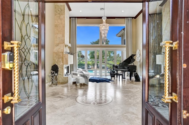 10427 Stonebridge Blvd, Boca Raton, FL 33498 - foyer featuring french doors, crown molding, and a chandelier