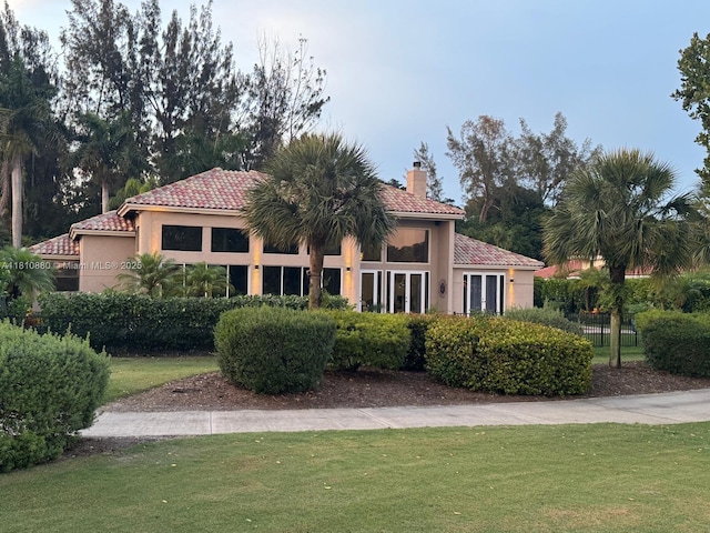 10427 Stonebridge Blvd, Boca Raton, FL 33498 - mediterranean / spanish house with a tiled roof, a chimney, and stucco siding