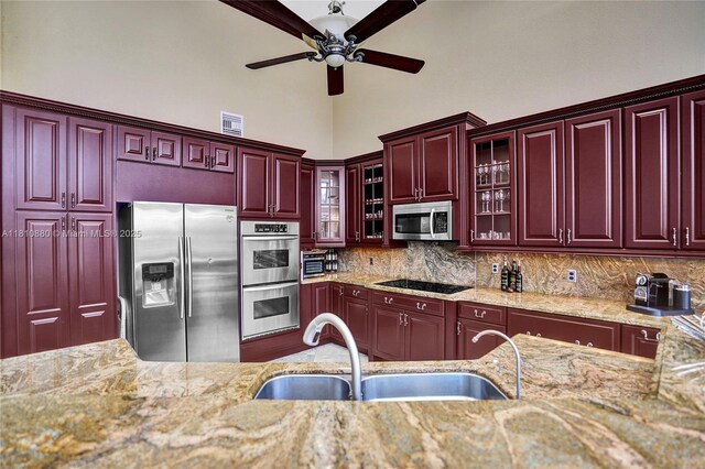 10427 Stonebridge Blvd, Boca Raton, FL 33498 - kitchen featuring stainless steel appliances, a sink, reddish brown cabinets, a ceiling fan, and light stone countertops