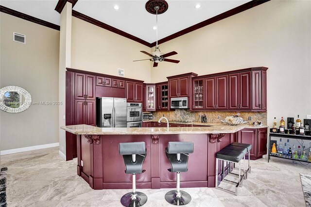 10427 Stonebridge Blvd, Boca Raton, FL 33498 - kitchen featuring stainless steel appliances, dark brown cabinets, ornamental molding, light marble finish floors, and baseboards