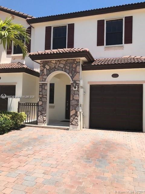 3721 NE 4th Unit 4Th, Homestead, FL 33033 - mediterranean / spanish house with a garage, stone siding, a tile roof, and stucco siding