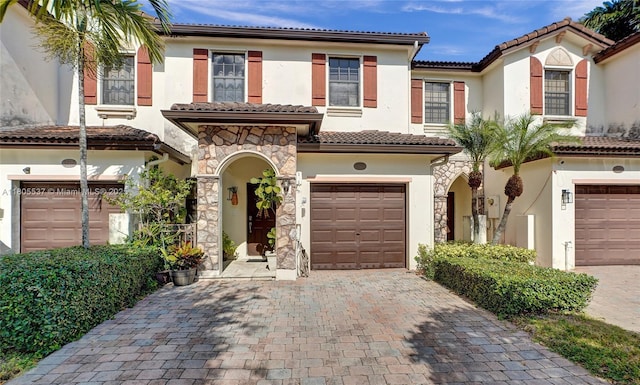3721 NE 4th Unit 4Th, Homestead, FL 33033 - view of front of home featuring stucco siding, a garage, decorative driveway, a tiled roof, and stone siding