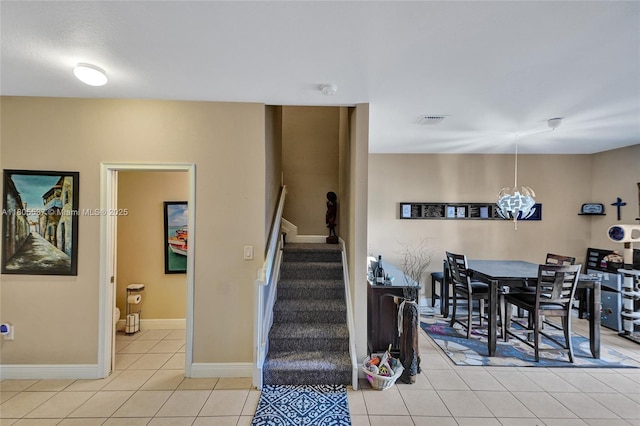 3721 NE 4th Unit 4Th, Homestead, FL 33033 - dining space featuring light tile patterned floors, stairway, baseboards, and a chandelier