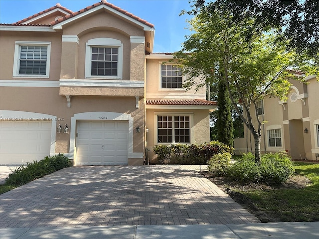 12464 SW 42nd St, Miramar, FL 33027 - view of front facade with stucco siding, a tiled roof, and decorative driveway