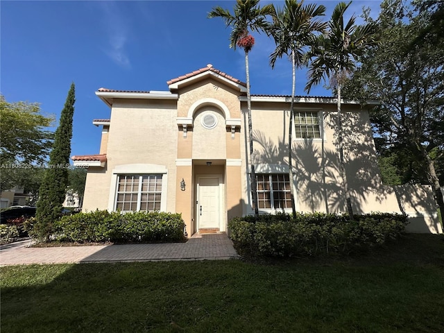 12464 SW 42nd St, Miramar, FL 33027 - view of front facade featuring stucco siding, a tile roof, and a front yard