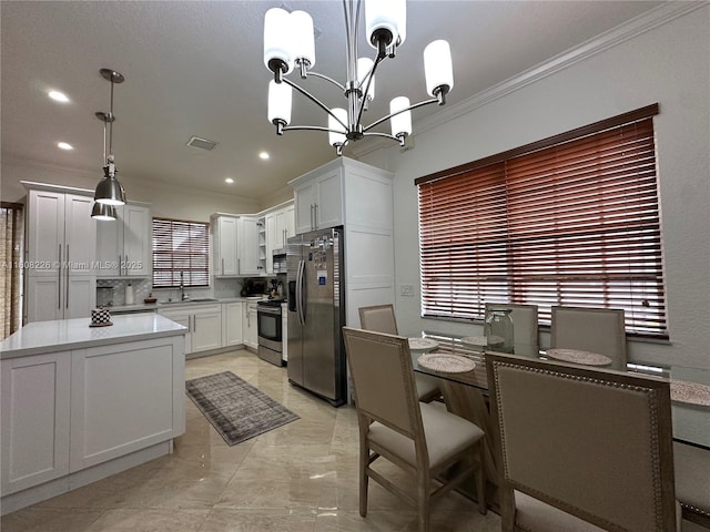 12464 SW 42nd St, Miramar, FL 33027 - kitchen featuring stainless steel appliances, crown molding, a chandelier, light countertops, and white cabinets