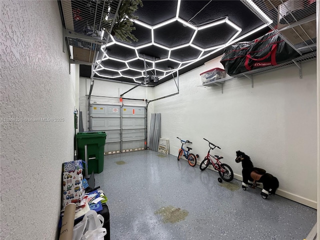 12464 SW 42nd St, Miramar, FL 33027 - garage with a textured wall, baseboards, and a garage door opener