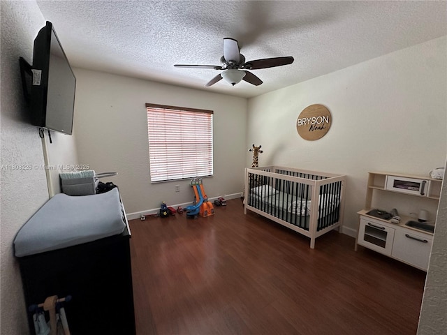 12464 SW 42nd St, Miramar, FL 33027 - bedroom with wood finished floors, a nursery area, a textured ceiling, ceiling fan, and baseboards