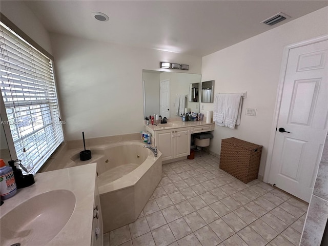 12464 SW 42nd St, Miramar, FL 33027 - bathroom featuring two vanities, a jetted tub, and tile patterned flooring