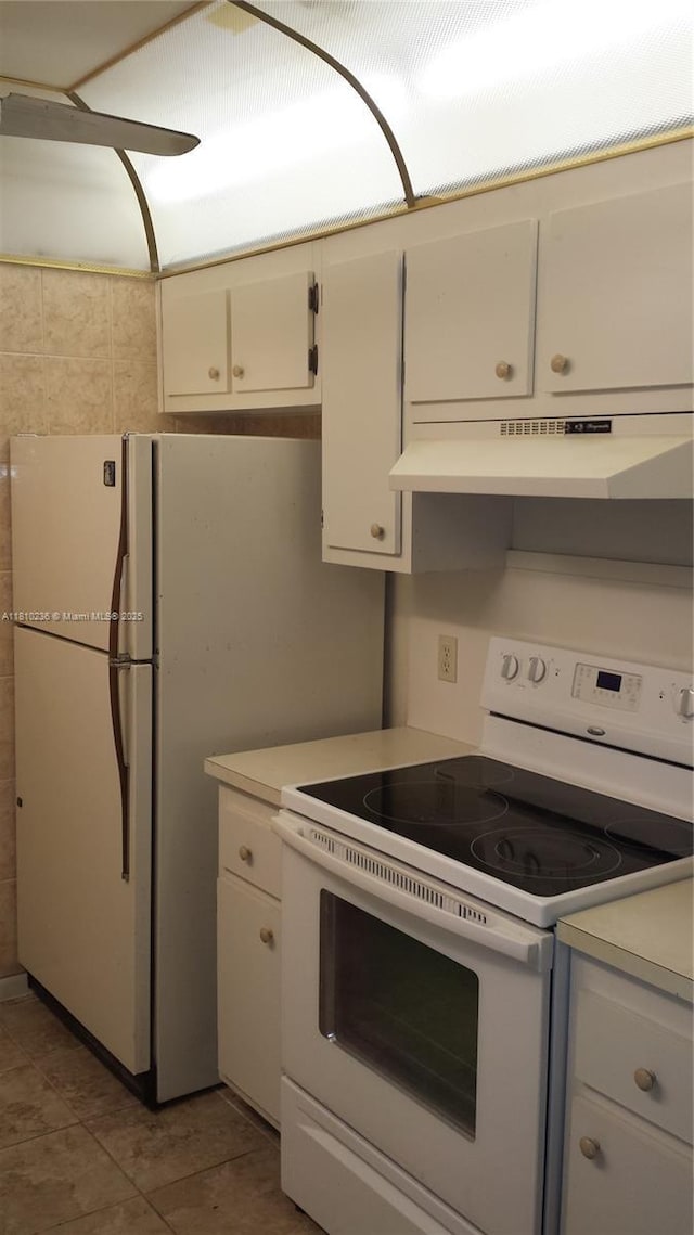 151 SW 134th Way Unit 206N, Pembroke Pines, FL 33027 - kitchen featuring white electric stove, light countertops, under cabinet range hood, white cabinetry, and tile patterned floors