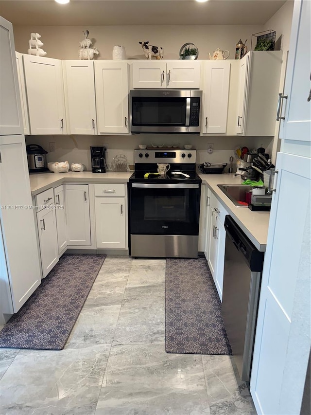 495 NE 5th Way, Florida City, FL 33034 - kitchen featuring appliances with stainless steel finishes, light countertops, and white cabinetry
